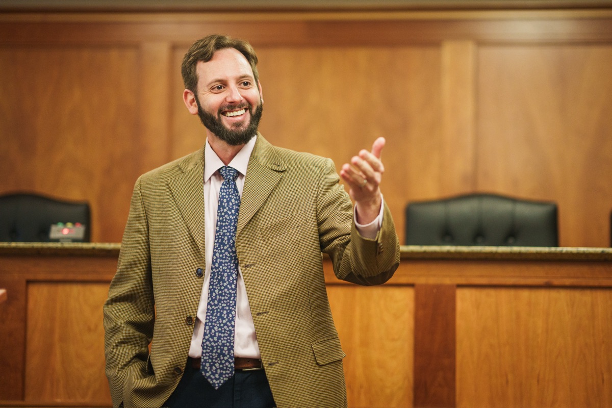 Professor Oranburg with students in a moot courtroom